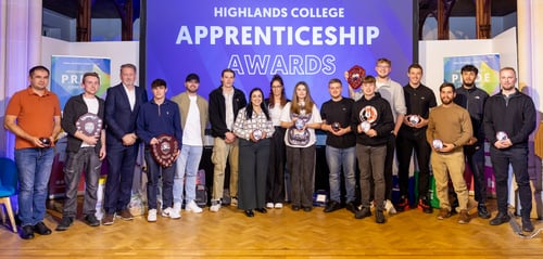 A group photo of apprentices all holding awards and smiling towards the camera.